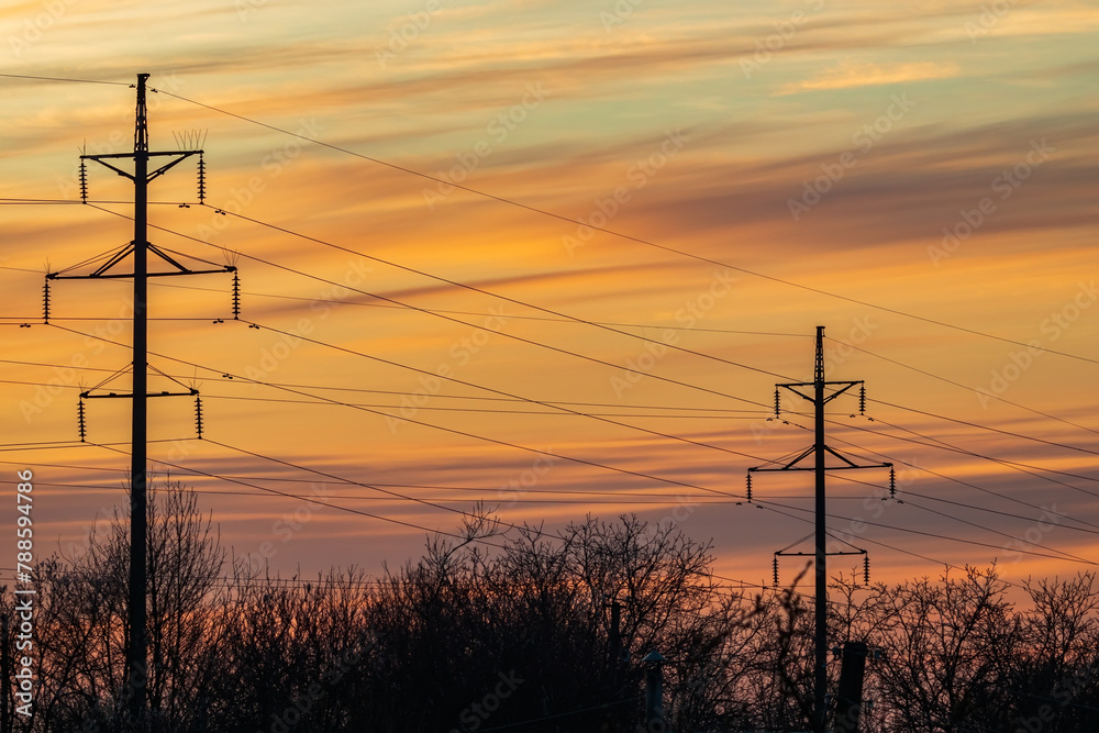 High-voltage overhead power line with wires and transmission tower ...