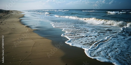 Sandy beach with waves rolling in. Suitable for travel and nature concepts #788594732