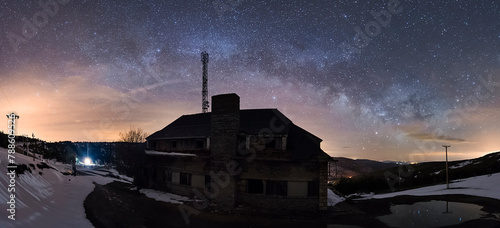 Old abandoned motel in Puerto de Piqueras between La Rioja and Soria on a cold starry night with the Milky Way visible in the sky and snowy ground