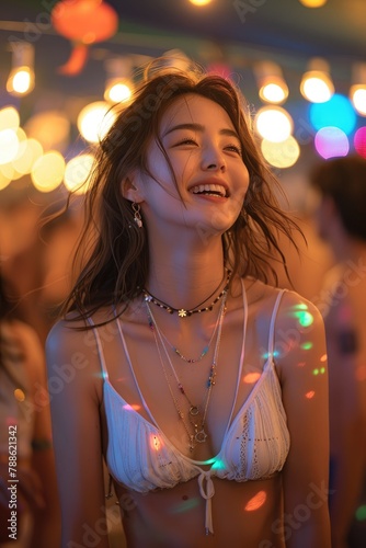 Pretty asian woman dancing at outdoor nightclub laughing joyfully. open air club with full of people dancing, amid colorful lights and bokeh effects.