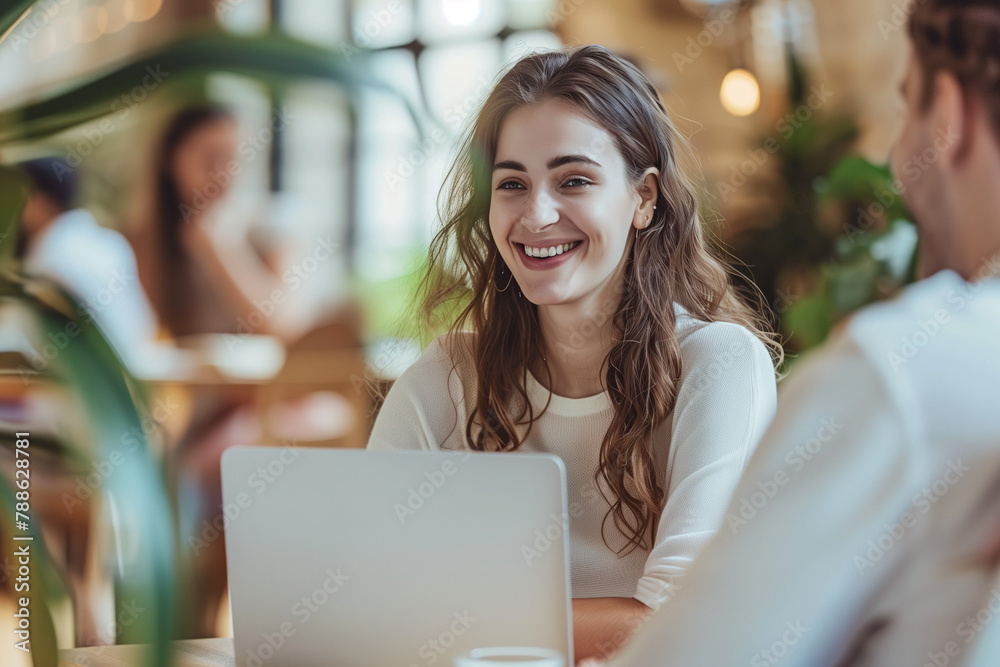 smiling businesswoman and businessman working together on laptop in office smiling businesswoman and businessman working together on laptop in office