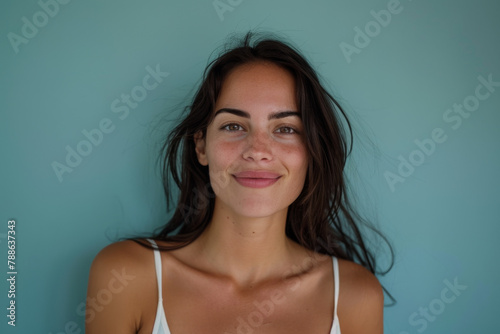 A woman in a white tank top smiles for the camera