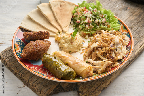 Middle Eastern or Arabic cuisine with a variety of mezze on a rustic concrete backdrop Food that is Halal. Cuisine from Lebanon, Turkey, and Egypt, with mixed veggies and a gorgeous table
