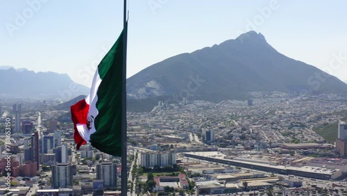 Aerial Panning Shot Of Flag At Mirador Del Obispado In City Near Mountains Against Sky - Monterrey, Mexico photo
