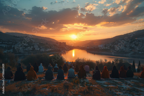Muslim, faith and group of people with praying at sunset for worship, spiritual healing and support in dua. Allah, Islam and religion in nature with hijab for praise, Maghrib and peace on Salah mat photo