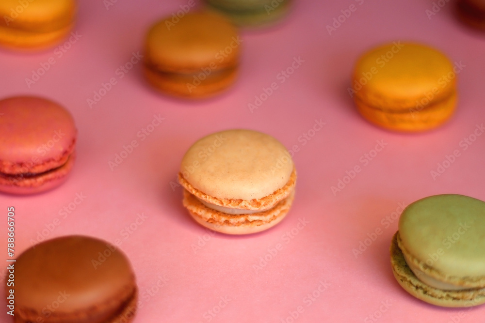 Colorful macarons on pink background. Selective focus. Colorful macarons on pink background. Selective focus.