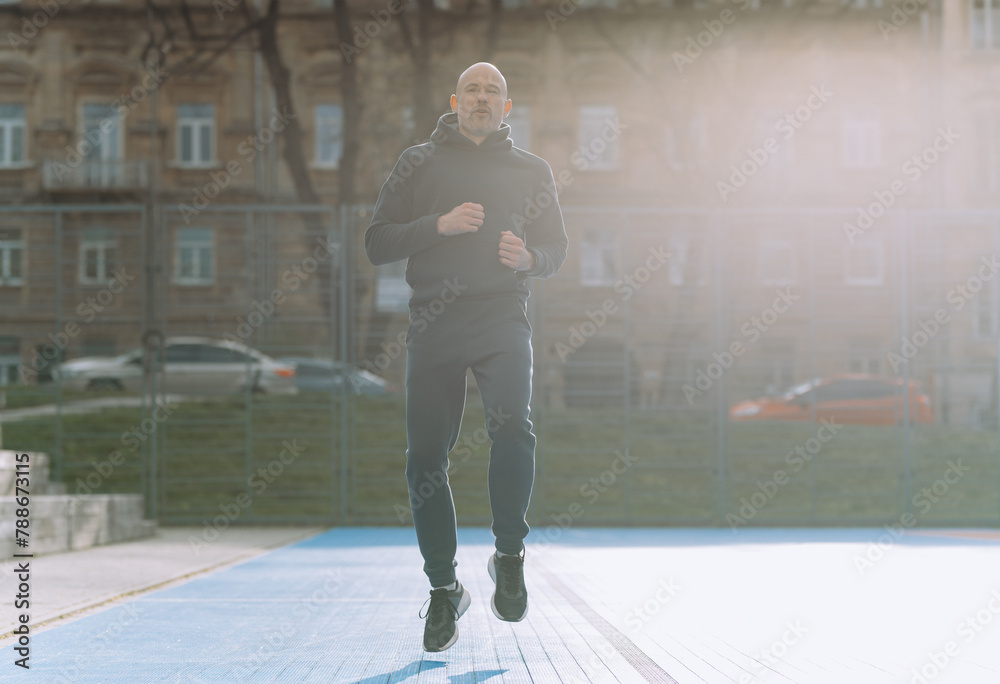 the athlete is doing running warm-up on the sports field the athlete is doing running warm-up on the sports field