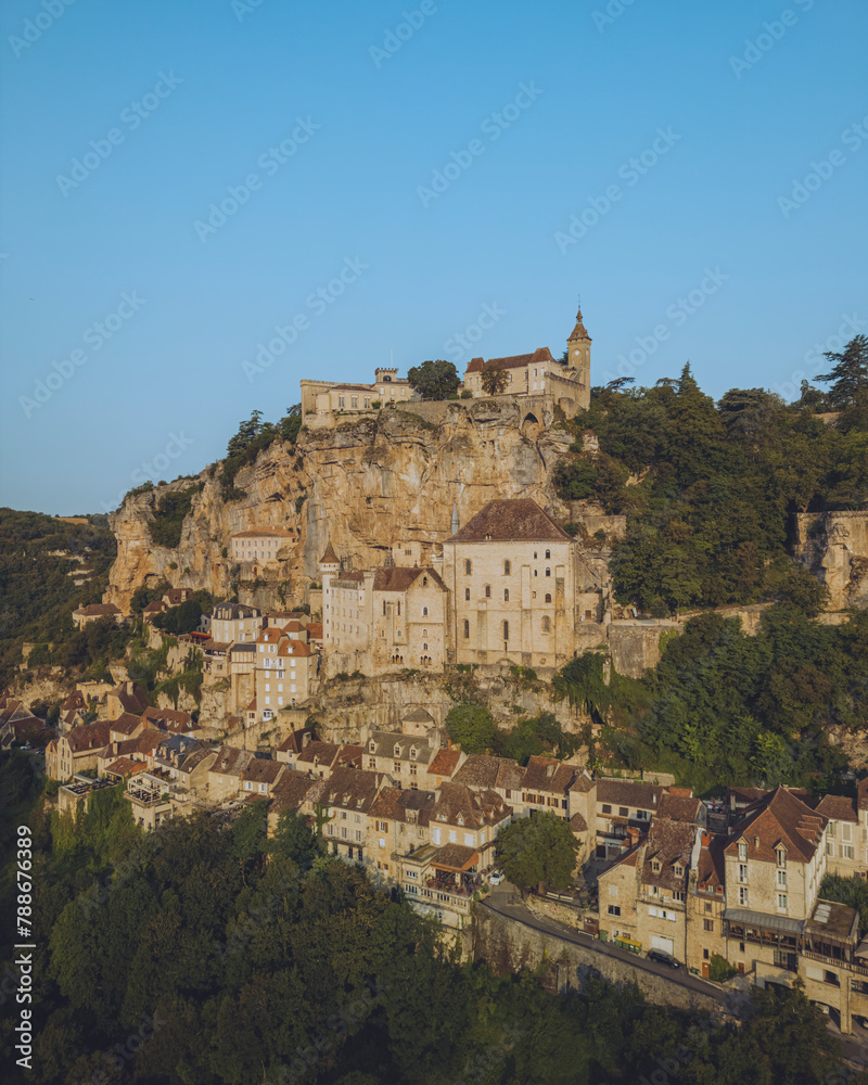 Aerial view of medieval town with historic stone buildings at sunset, Rocamadour, Lot, France. Aerial view of medieval town with historic stone buildings at sunset, Rocamadour, Lot, France.