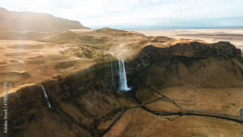 Aerial drone view of Seljalandsfoss waterfall during sunrise in autumn, Southern Iceland.
