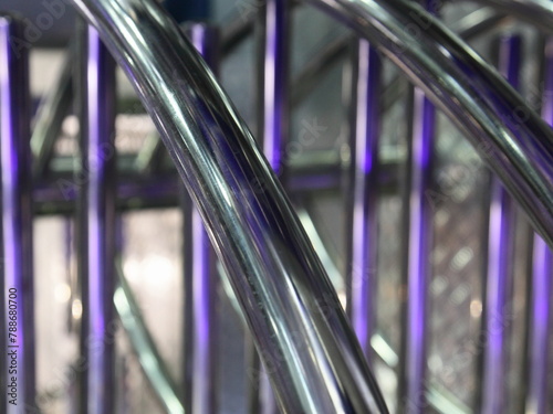 Obraz na płótnie industrial abstract shiny metal spiral background with vertical and diagonal chrome pipe lines w salonie