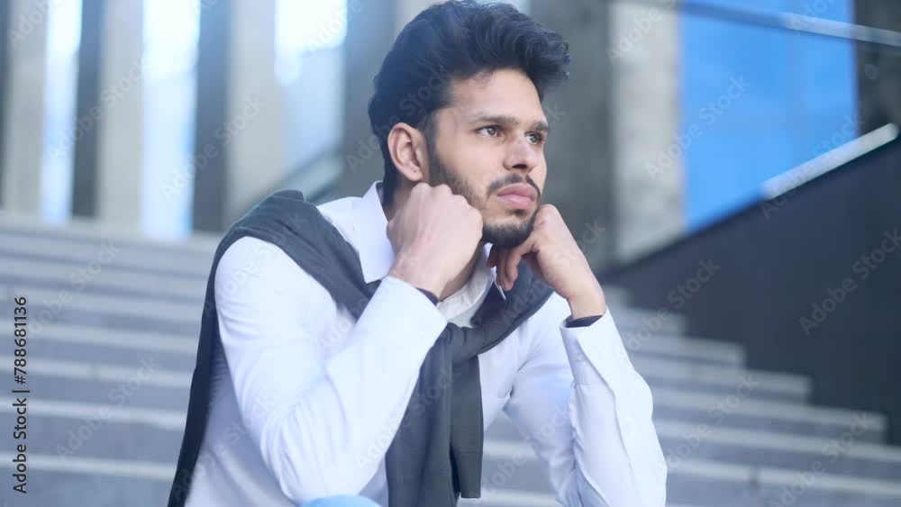 Worried stressed bearded man entrepreneur sitting on stairs feeling bad about losing job financial crisis failure with deal overworked or mental health problem at modern business centre outdoors alone Worried stressed bearded man entrepreneur sitting on stairs feeling bad about losing job financial crisis failure with deal overworked or mental health problem at modern business centre outdoors alone