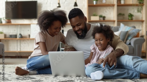 Happy African American family using laptop together at home