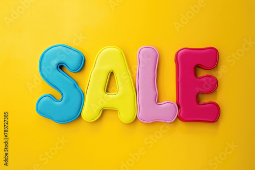 Word sale spelled out in colorful letters on bright yellow background, creating vibrant and eye-catching display photo