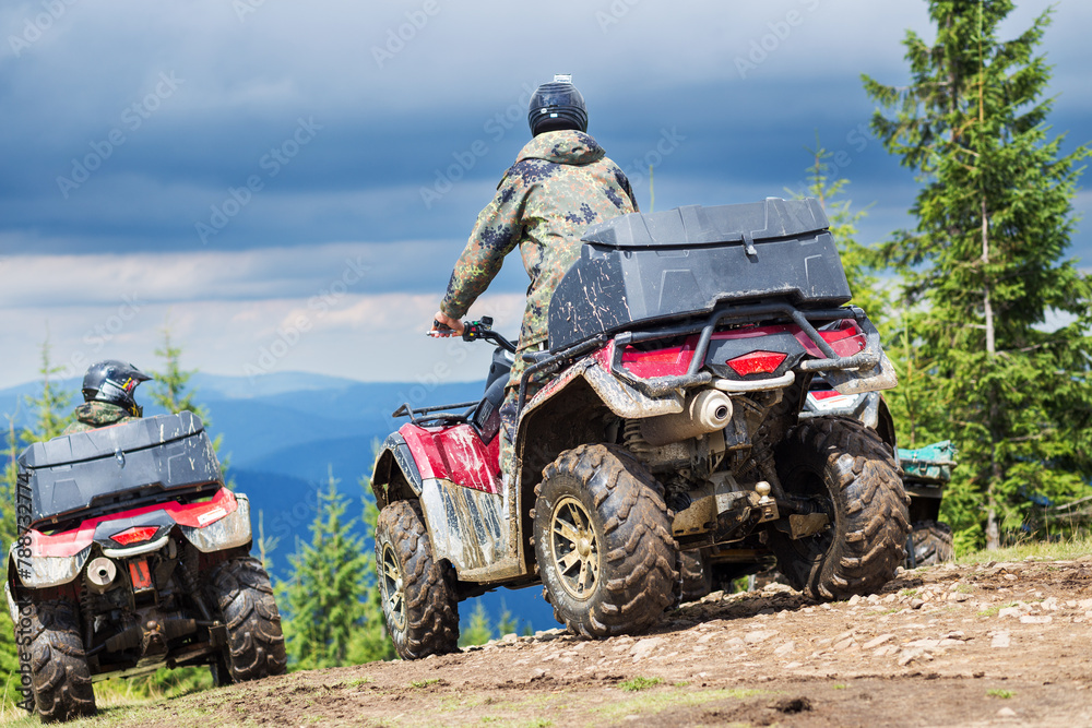 Tourist on ATV driving through the mountains in stormy weather Tourist on ATV driving through the mountains in stormy weather