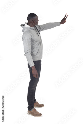 side view of a man showing victory sign with fingers on white background
