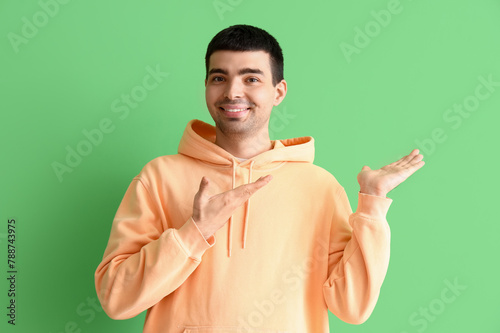 Young man showing something...