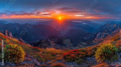  The sun descends behind mountain peaks  foreground showcases mountains
