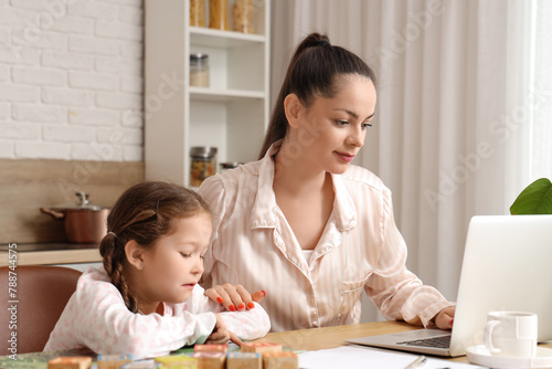 Working mother with her lit...