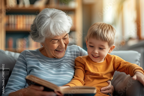 Grandmother with his grandson, reading an old book together and have a cheerful time. Cosy interior bookshelves in the background