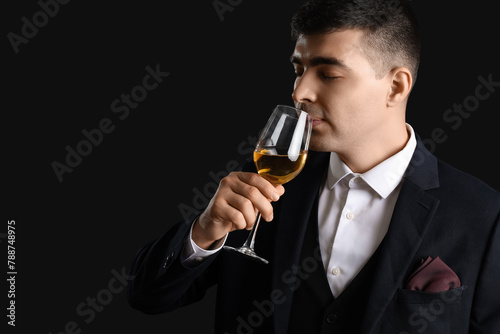 Young sommelier with glass ...