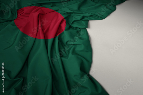 waving national flag of bangladesh on a gray background. © luzitanija