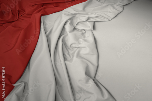 waving national flag of indonesia on a gray background.