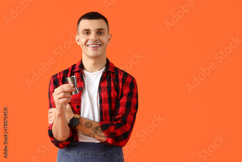 Young male bartender with m...