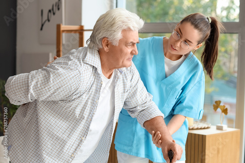 Young nurse helping senior ...