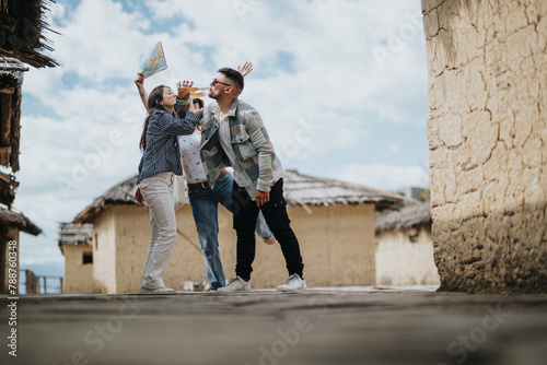 A cheerful friends on vacation in an old village, exploring with a map and a camera, enjoying their holiday together.