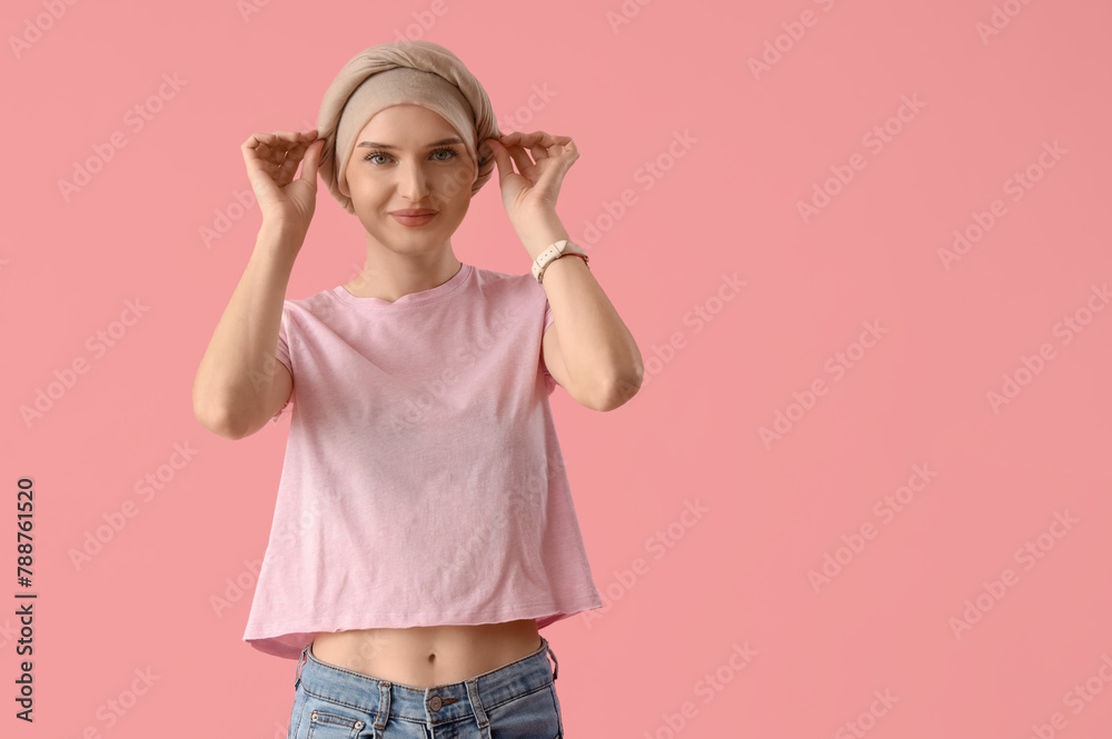 Smiling young woman after chemotherapy on pink background. Stomach cancer concept - obrazy, fototapety, plakaty 
