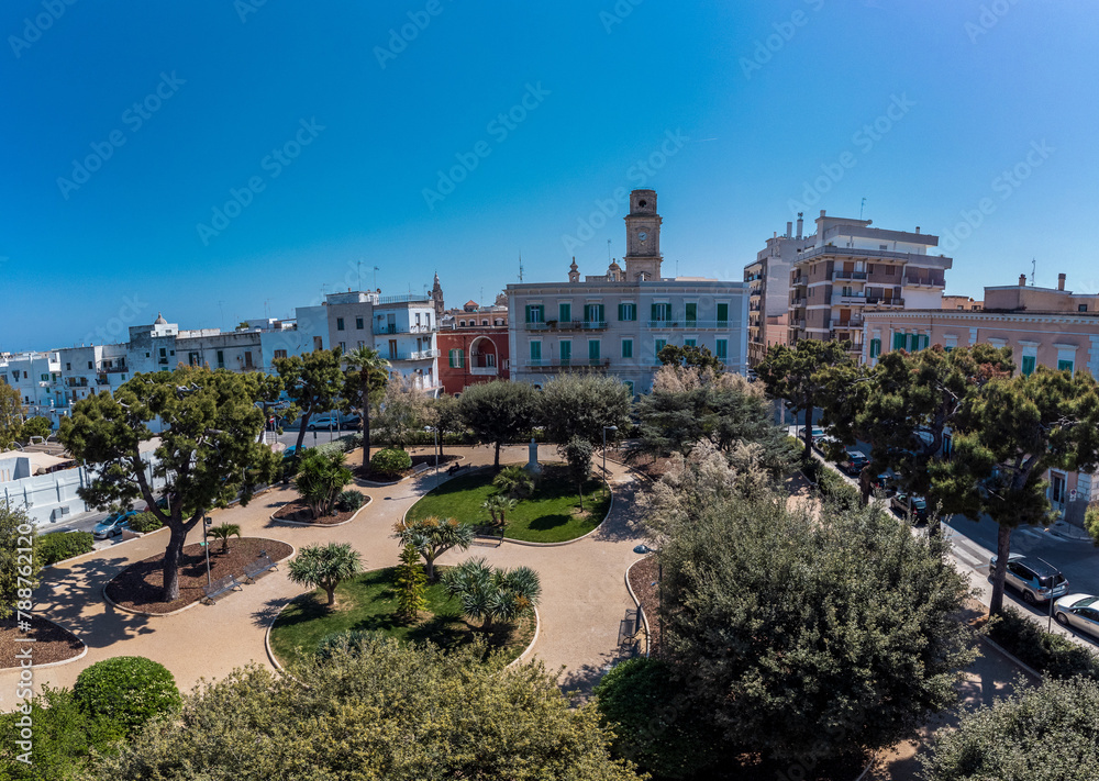 Drone view of Fontanelle park in the centre of Monopoli, a beautiful italian coastal town in the region of Puglia. Park and church with surrounding buildings.