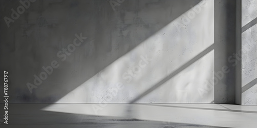 Minimalistic abstract empty gray concrete stone wall mockup background for product presentation. Neutral industrial interior with light and shadow from window.