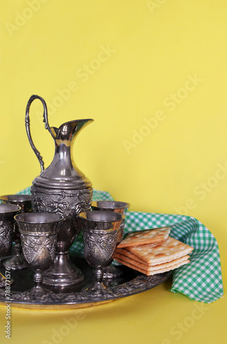 Traditional drinks set with crackers and a jug on a yellow background