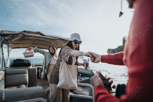 Helpful boatman giving a hand to a stylish woman getting off a leisure boat on a sunny day