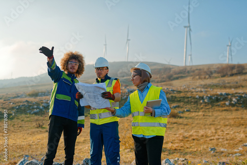 A team of engineers and workers oversees a wind turbine project at a modern wind farm, working together to ensure the efficient generation of renewable energy