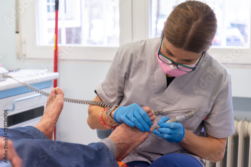 Podiatrist Treating Senior Patient's Foot photo