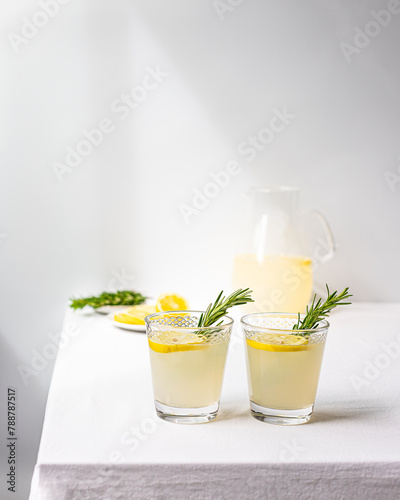 Refreshing Lemonade in Glasses with Rosemary Garnish photo