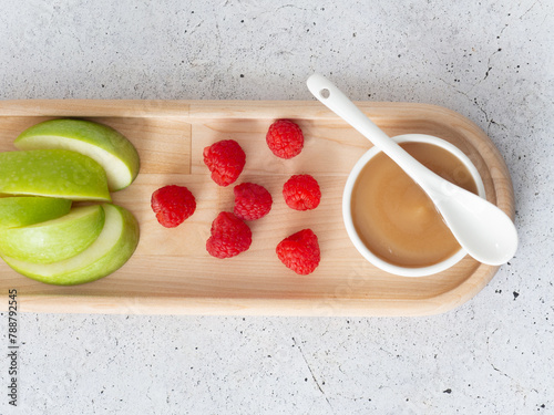 applesauce in a saucepan, with raspberry and apple fruit