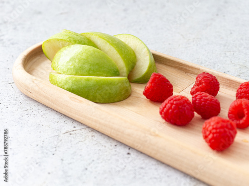 applesauce in a saucepan, with raspberry and apple fruit