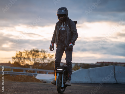 A man rides on an electric unicycle. Mono Wheel riding (EUC) , protective gear , helmet and gloves