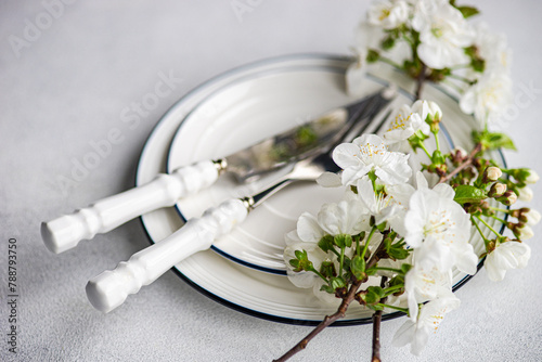 Spring table setting with cherry blossoms and cutlery photo