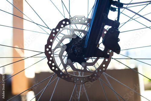 Close-up of E-Bike Front Wheel with Stainless Steel Brake Disc and Caliper