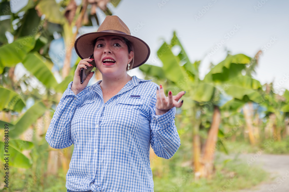 Woman talking on a cell phone at a banana farm.