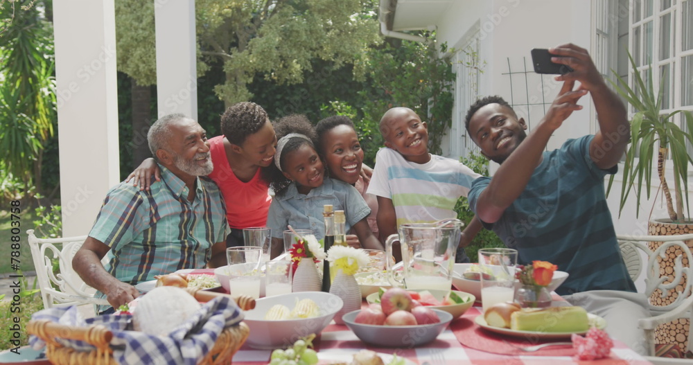 A diverse family is taking selfie during outdoor meal A diverse family is taking selfie during outdoor meal