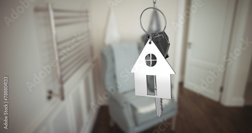 House-shaped keychain on keys implies home ownership
