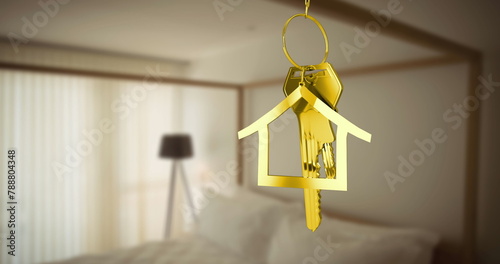 Golden house-shaped keychain with keys hanging in bedroom