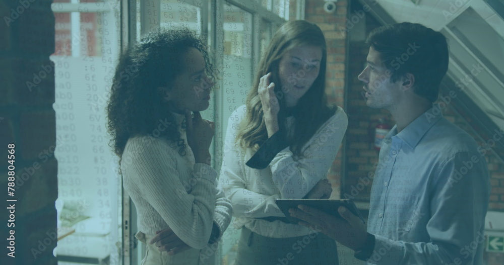 Obraz premium Diverse group of young adults discussing over tablet