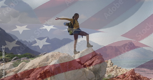 Biracial woman on rock with American flag.