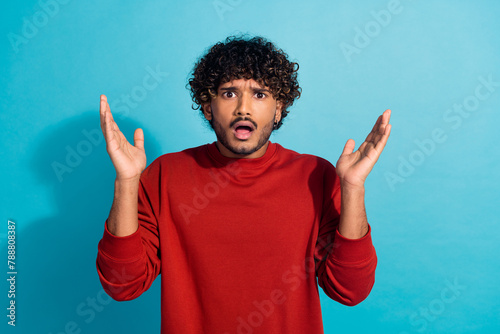 Photo of impressed crazy young man raise hands open mouth cant believe isolated on blue color background