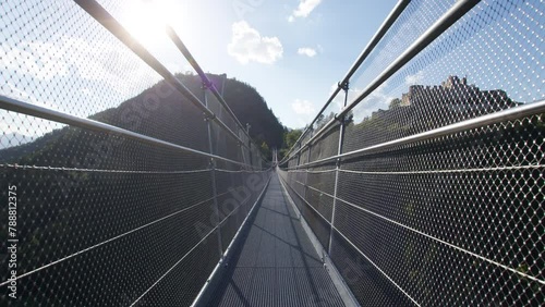 POV Walking across a highline suspension Bridge in the Alps with a scenic view photo